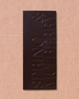 Dark chocolate bar with 'Spring & Mulberry' branding on a beige background