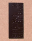 Dark chocolate bar with 'Spring & Mulberry' branding on a beige background