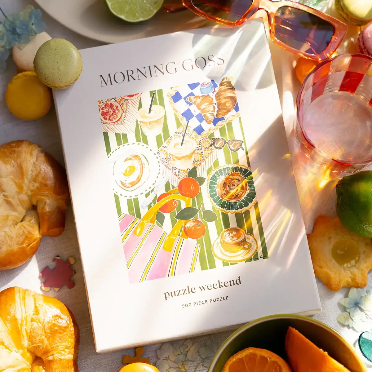 Puzzle box titled 'Morning Goss' with a colorful illustration on a table with pastries and fruit.