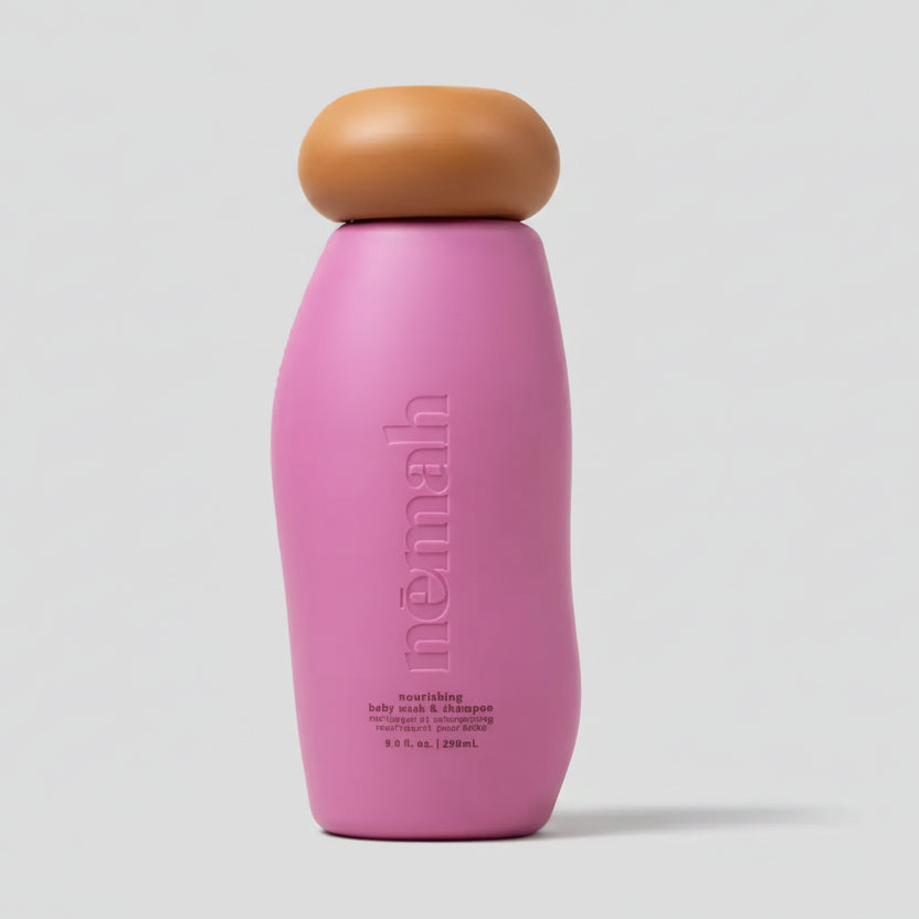 Pink bottle with brown cap on a light gray background