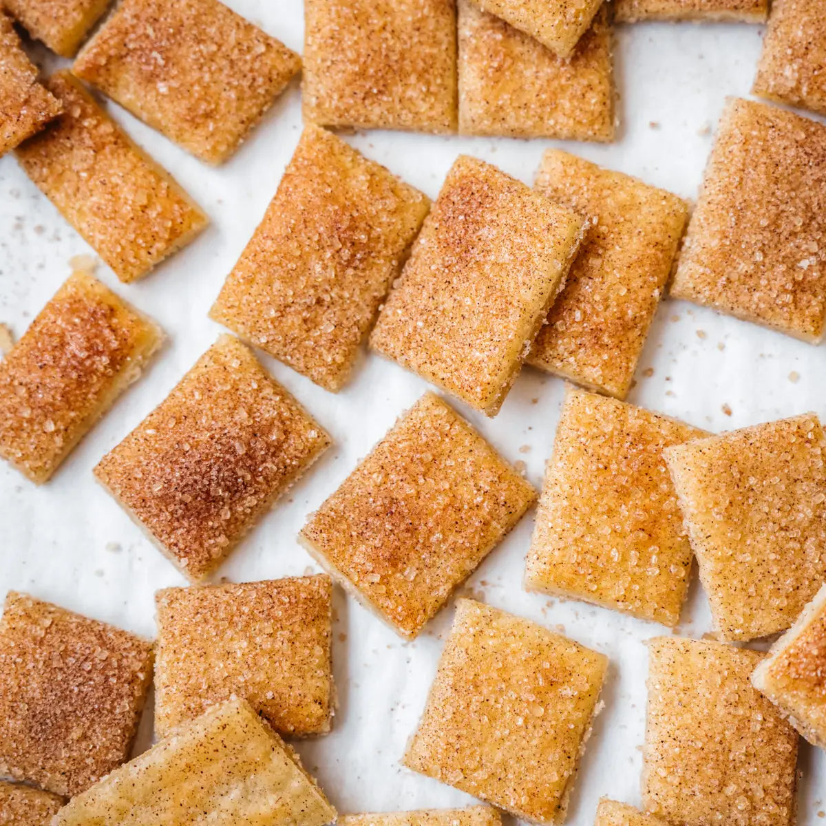 Square brown sugar cubes on a white surface