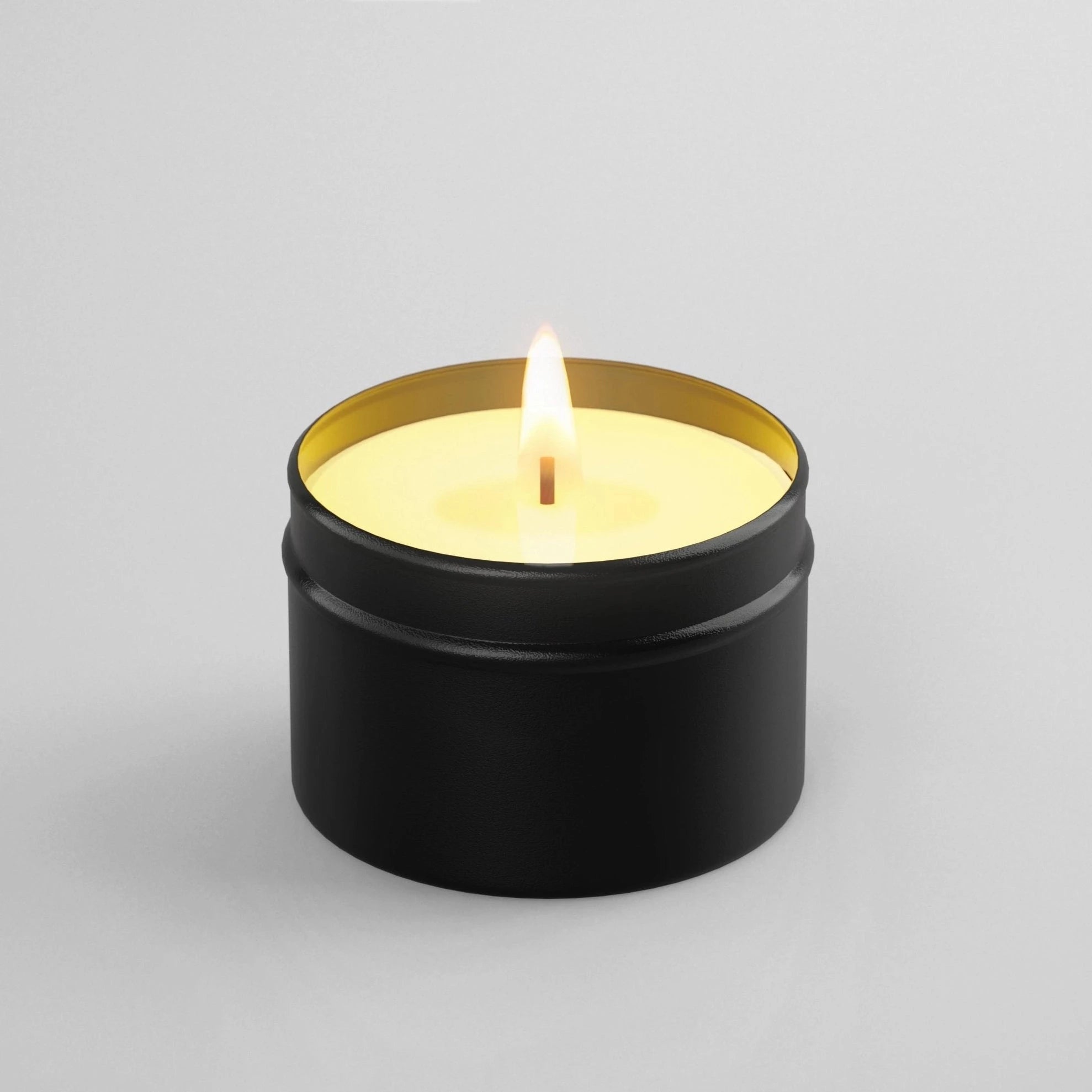 candle in black tin burning 