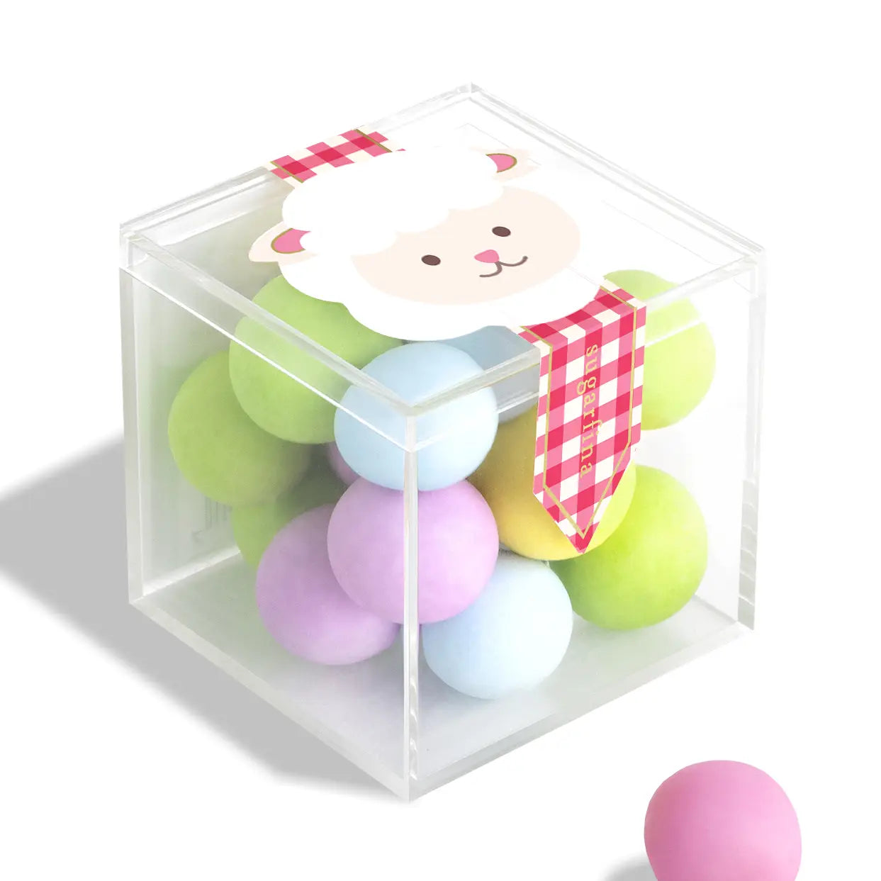 Pastel-colored play balls with a cartoon sheep character in a clear cube on a white background
