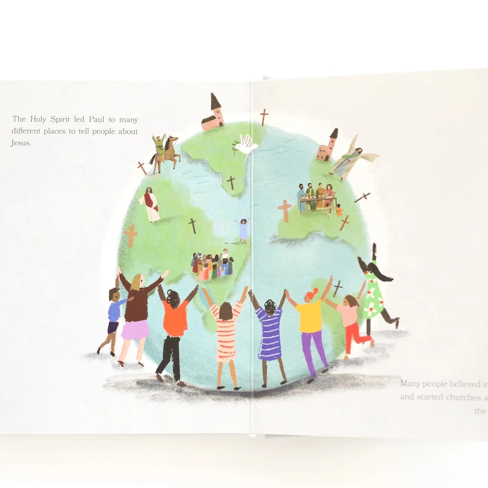 book opened to page of children hugging the world