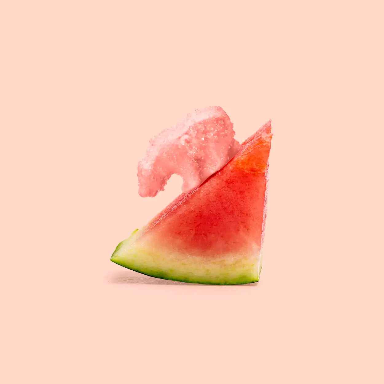 Slice of watermelon with a piece of pink grapefruit on a light pink background