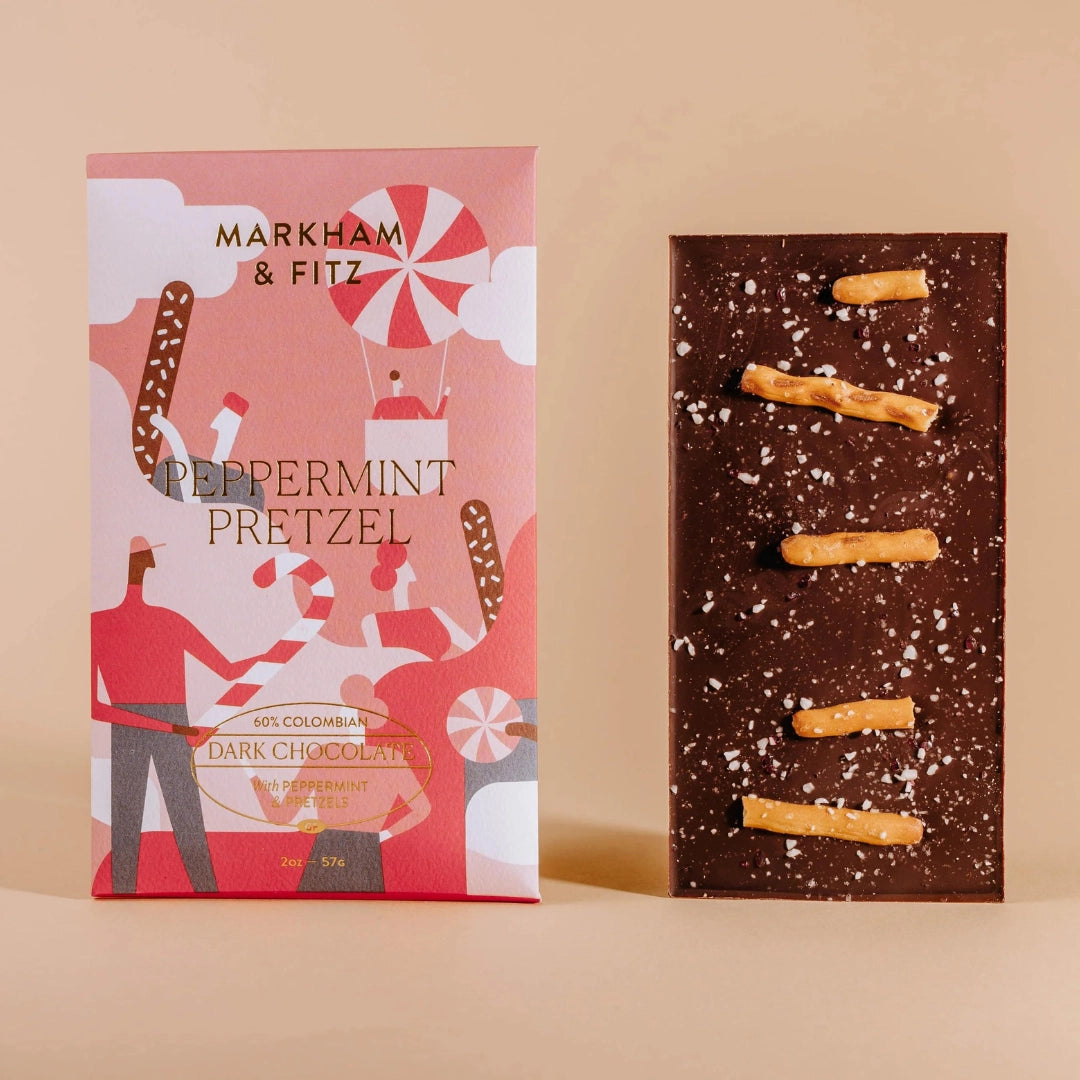Markham & Fitz peppermint pretzel chocolate bar packaging and bar on a beige background