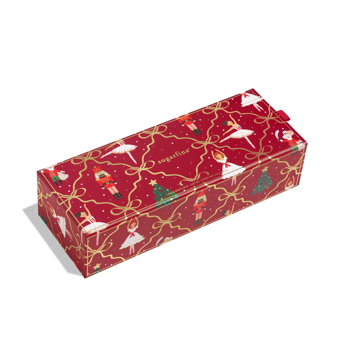 A rectangular gift box wrapped in festive red paper with gold ribbon motifs, ballerina figures, nutcrackers, Christmas trees, and the word 'agafina' printed on the side, shown on a white background.