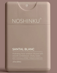 Noshinku Santal Blanc hand sanitizer packaging on a brown background