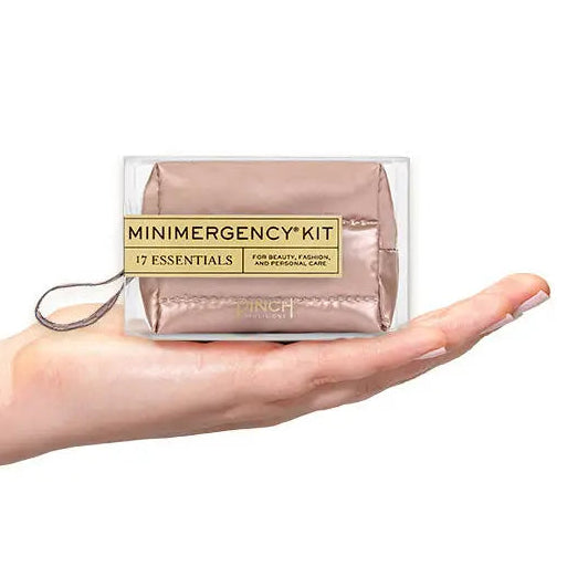 Minimergency kit held in a hand on a white background
