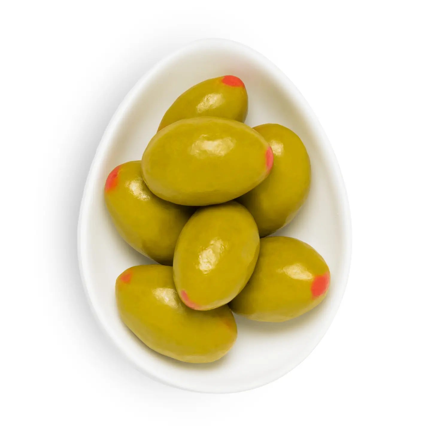 Green olives with red tips on a white plate against a white background
