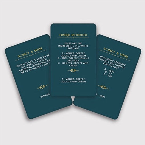 teal colored cards with gold text with trivia questions 