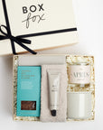 BOXFOX Creme gift box packed with oatmilk hot chocolate, stone luxe cozy socks, salt and stone santal hand lotion, apres candle and grey mug