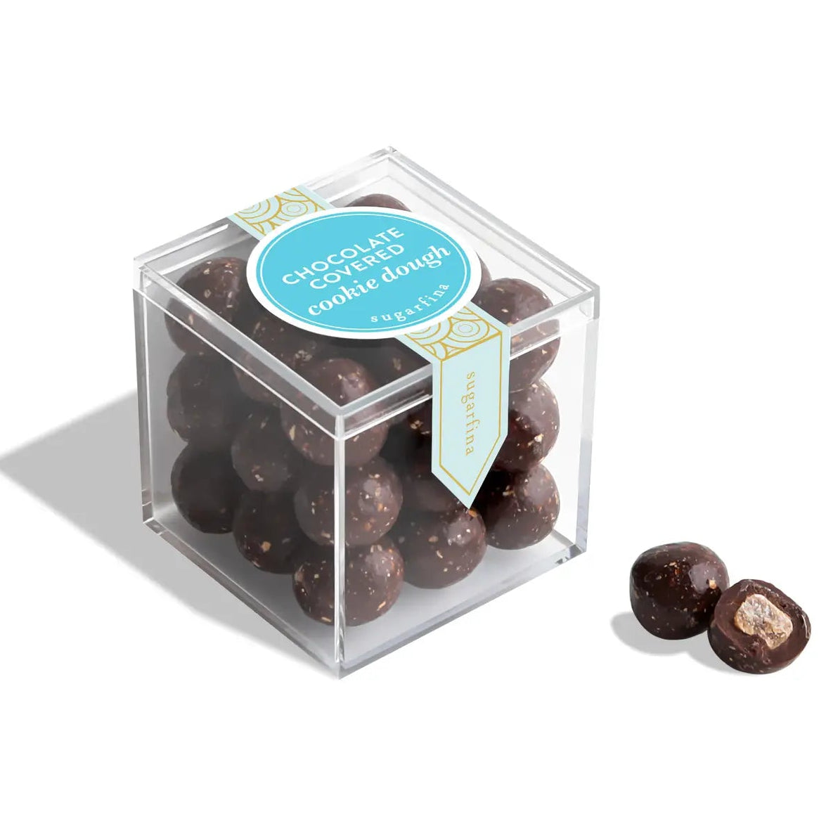 Clear cube container with chocolate cookie dough balls and a blue label on a white background