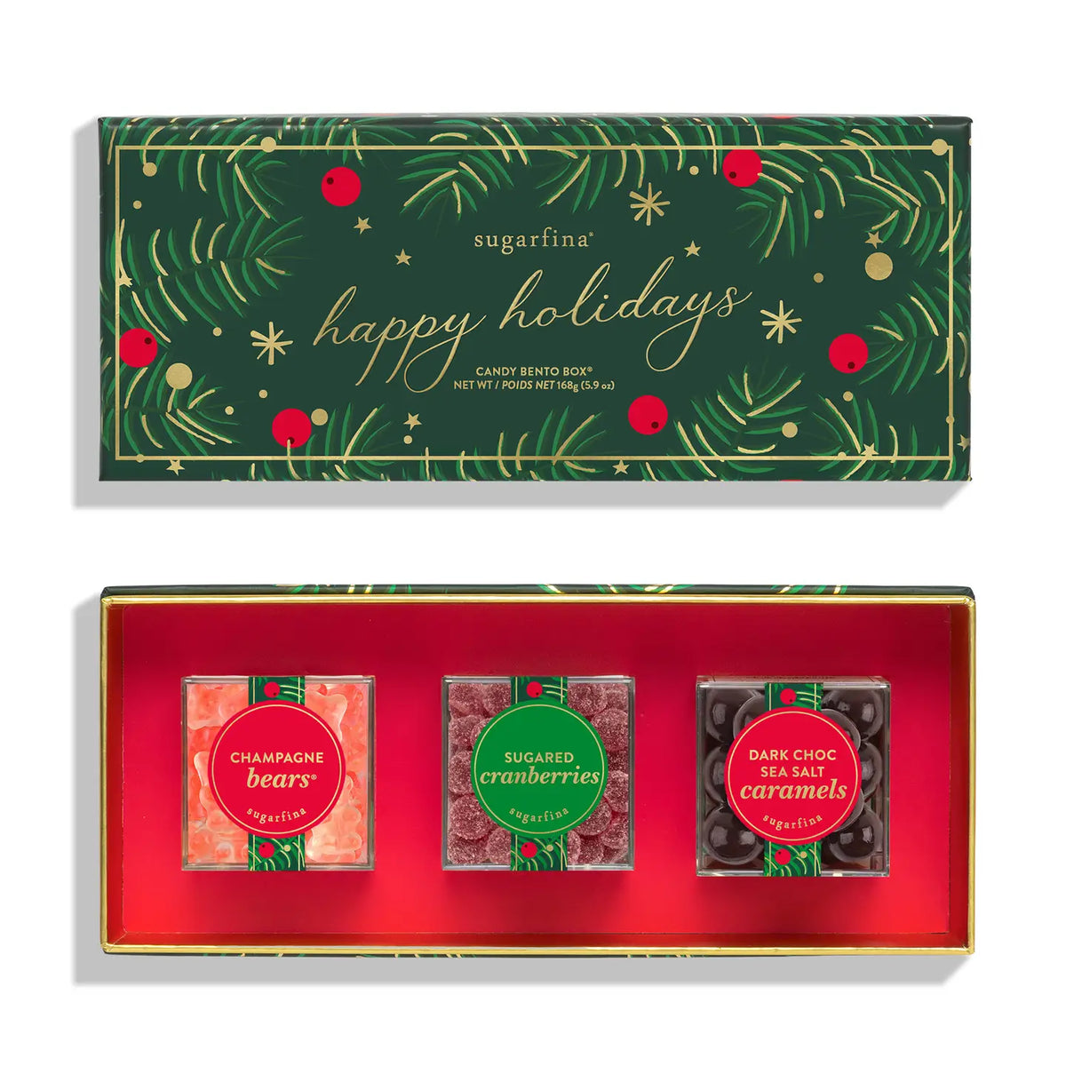Sugarfina Happy Holidays Candy Bar Gift Set, featuring a dark green illustrated box lid with gold and red holiday details, and an open red box containing three individually wrapped candy bars: Champagne Bears, Sugared Cranberries, and Dark Chocolate Sea Salt Caramels.