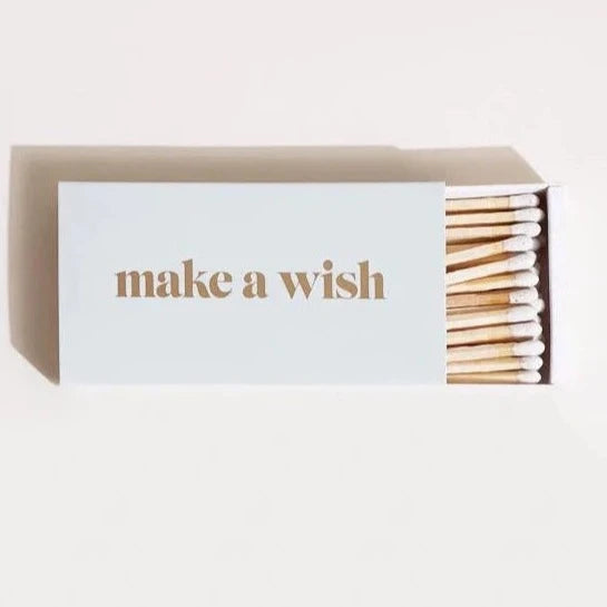 White Match Box with drawer of matches pulled out. Gold foil "Make a Wish" on top of box.