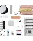 Collection of mini emergency kit contents including a mirror, floss, bandage, and other small items on a white background.