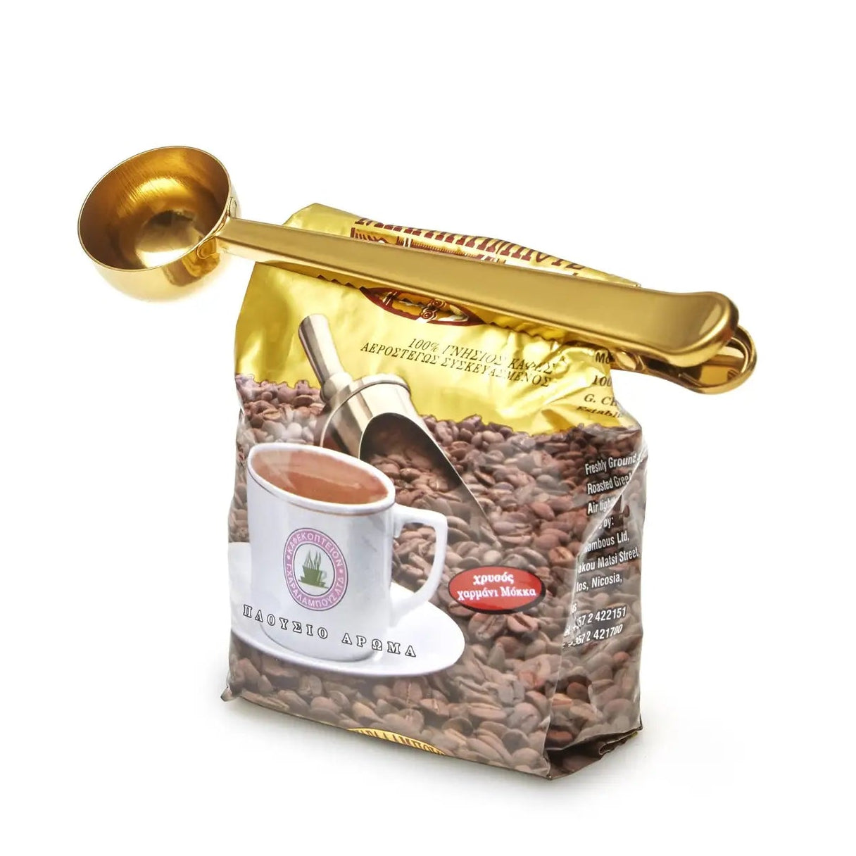 Coffee bag with gold scoop and measuring spoon on a white background
