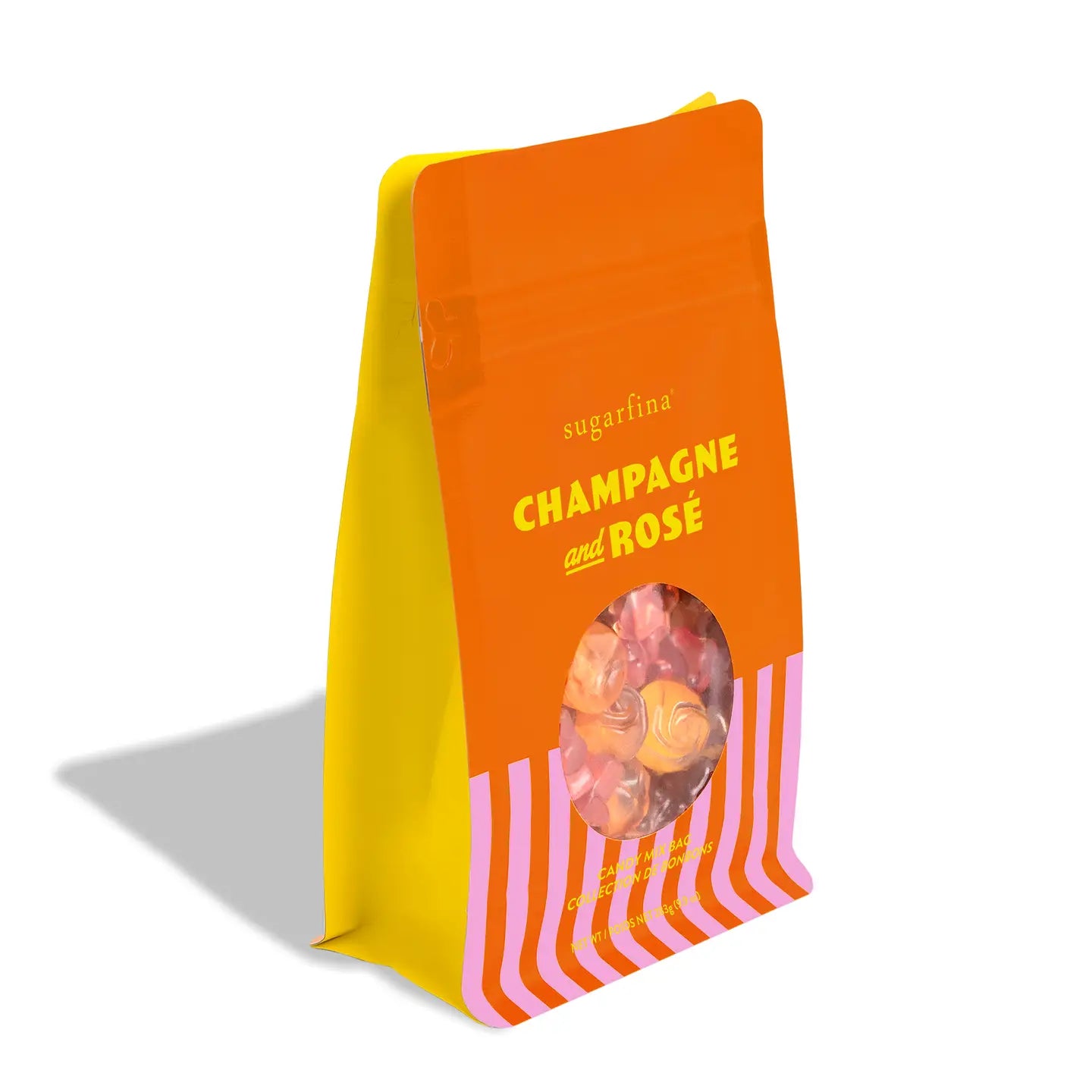 A stand-up pouch of sugarfina Champagne and Rosé candy, featuring a bright orange top half with yellow text, a yellow side panel, and pink-and-white diagonal stripes on the bottom, with a clear window showing the candy inside.