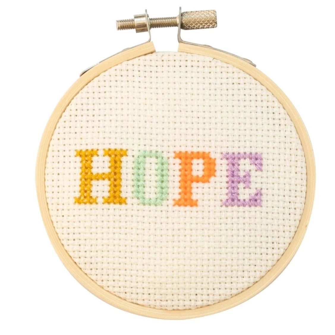 embroidery hoop with pastel colored letters spelling HOPE in the center