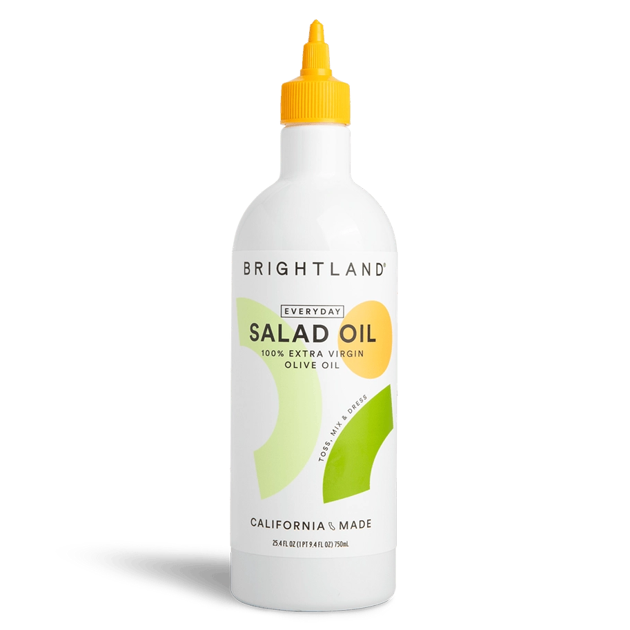 Bottle of Brightland salad oil on a white background