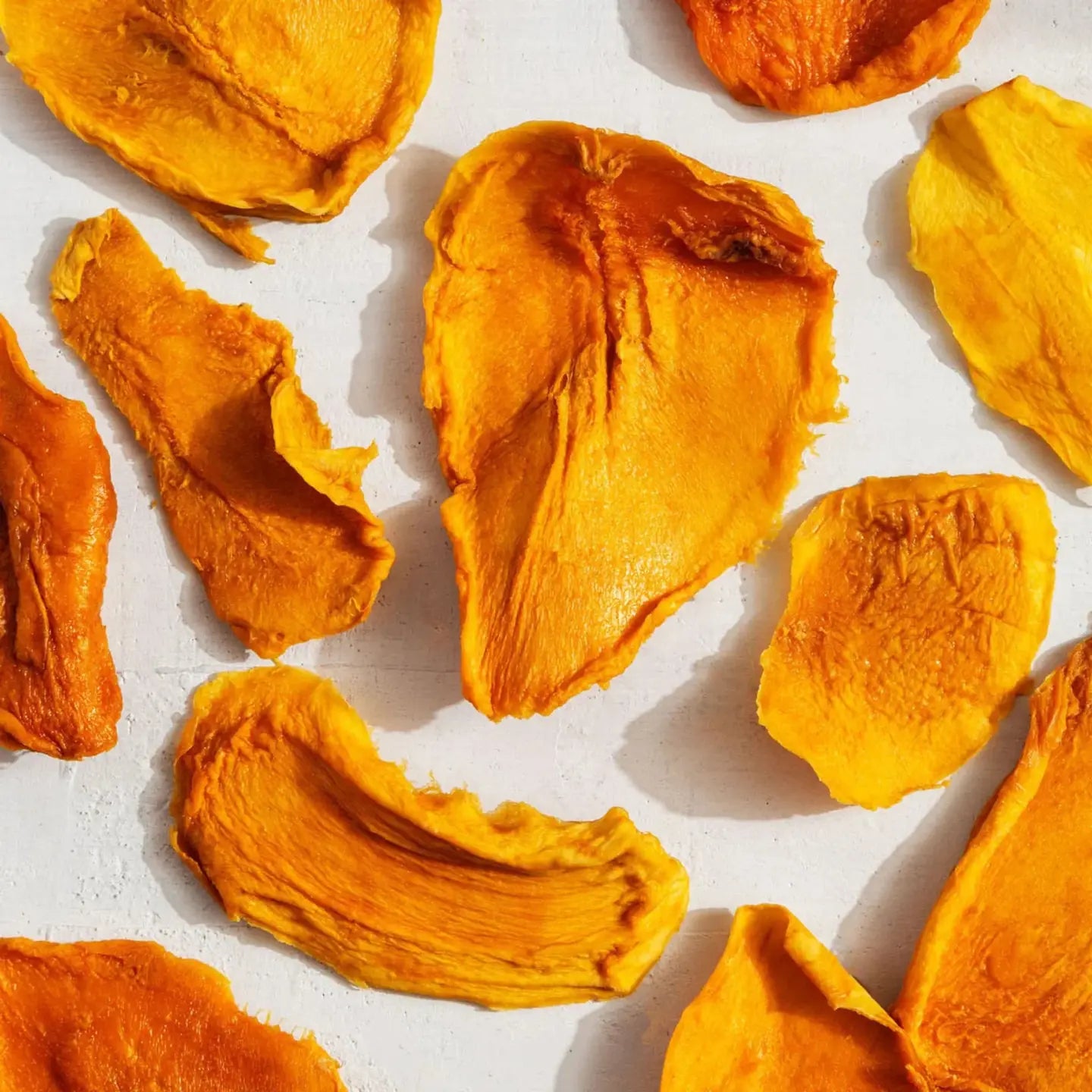 Dried mango pieces on a light background