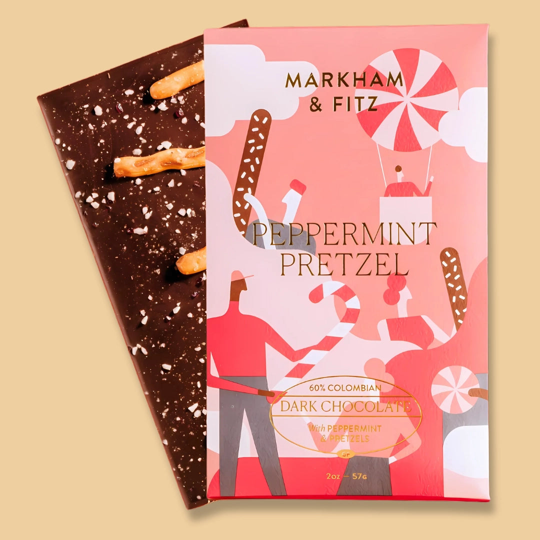 Dark chocolate bar with a peppermint pretzel flavor and its packaging on a beige background