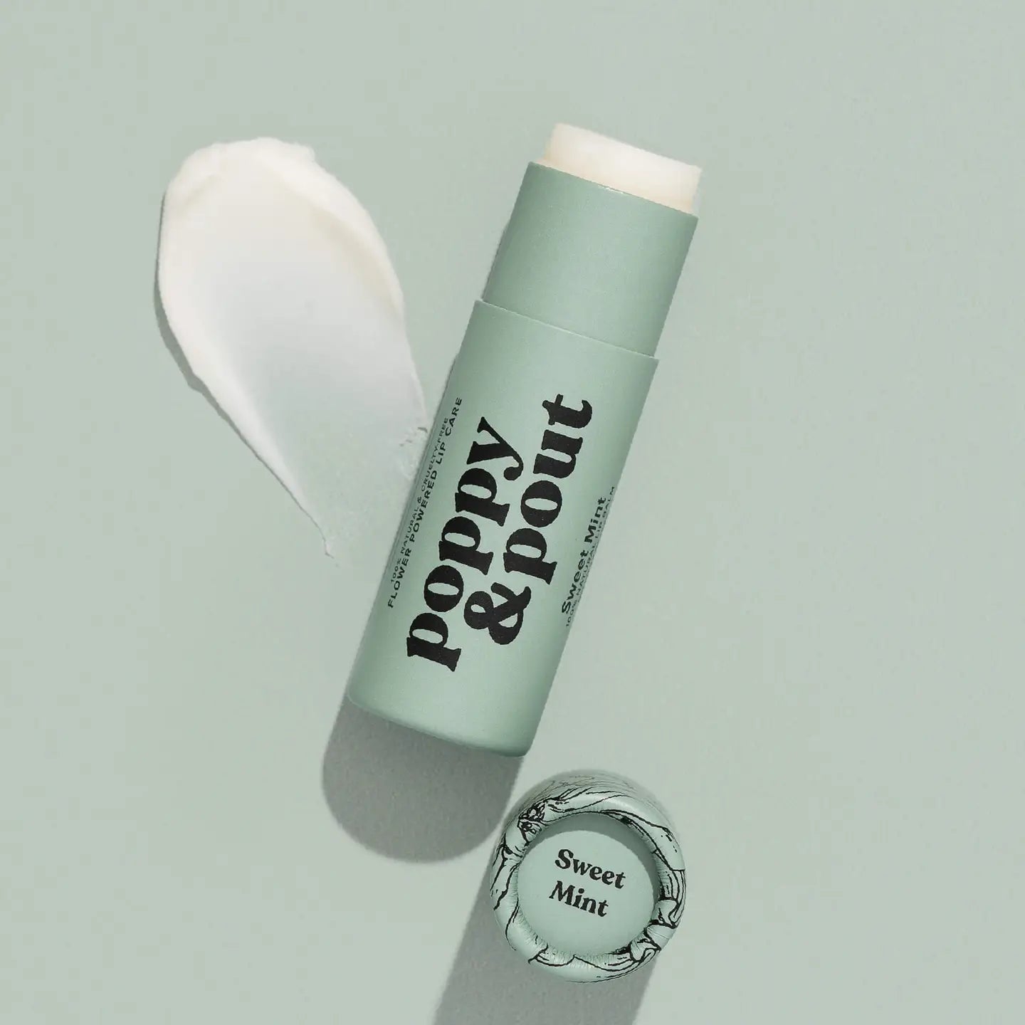 Green lip balm with 'Poppy &amp; Pout' branding on a light gray background