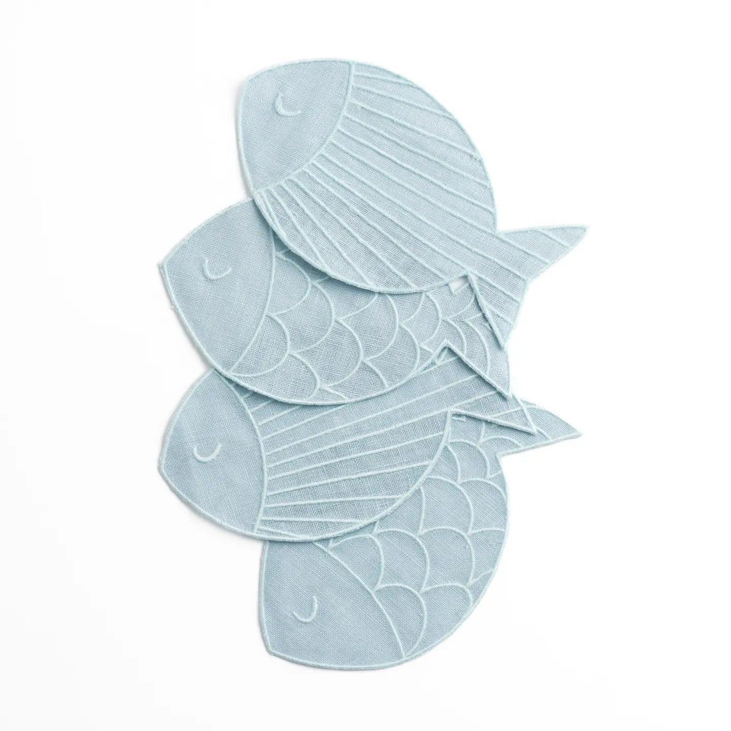 Four light blue fish-shaped bath towels stacked on a plain white background.