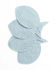Four light blue fish-shaped bath towels stacked on a plain white background.
