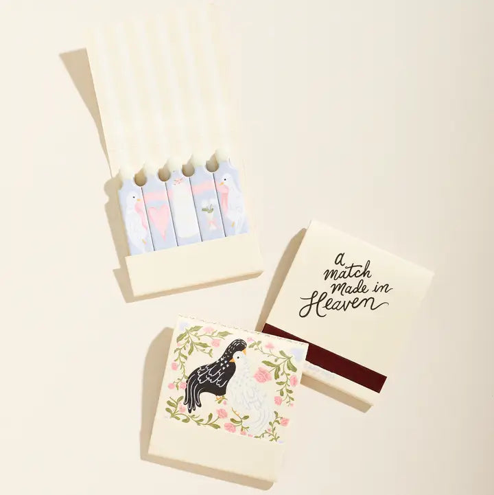 Set of matches with decorative packaging featuring a bird illustration and text on a beige background