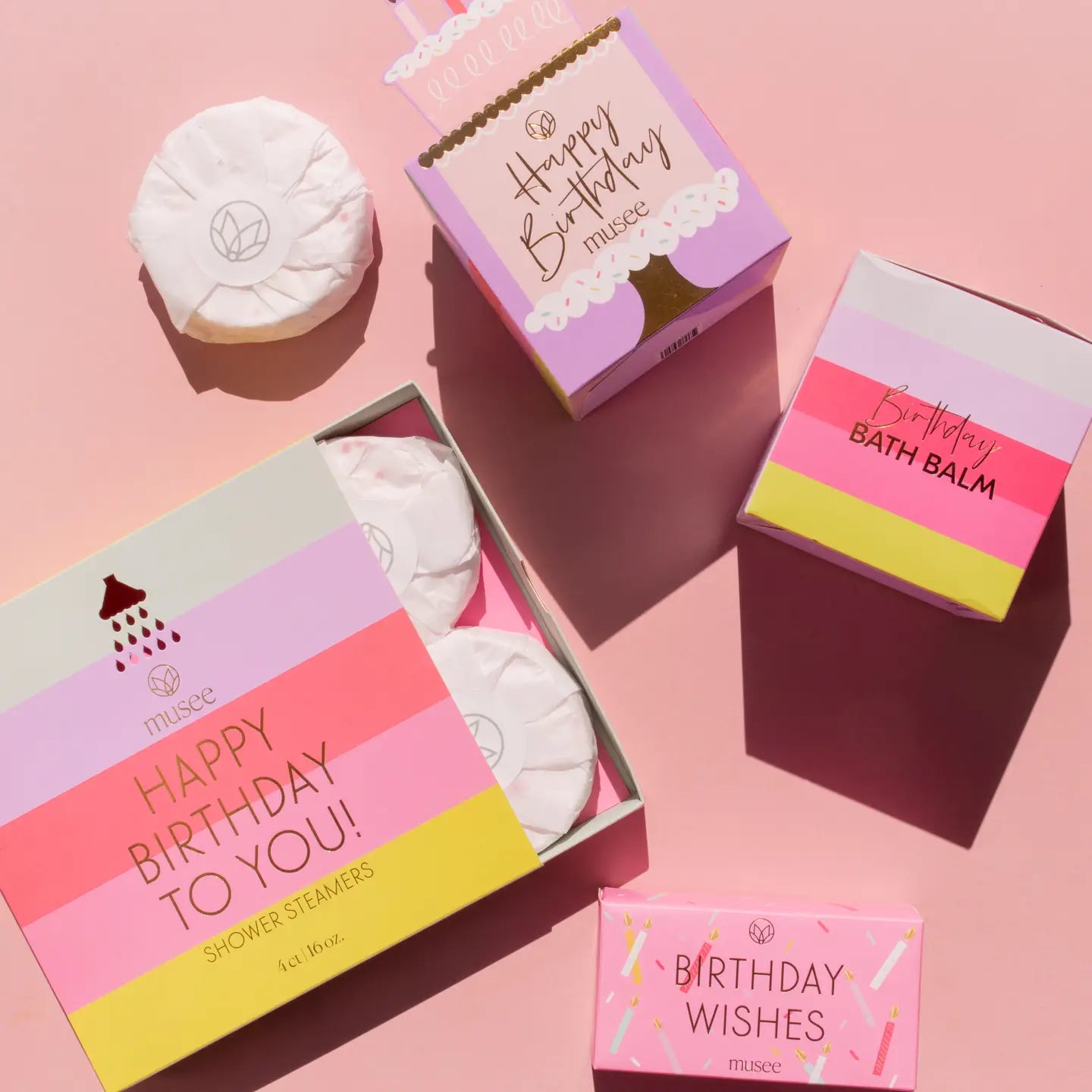 Birthday-themed bath and shower products on a pink background