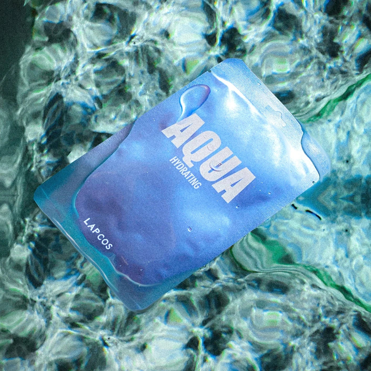 Blue 'Aqua' hydration pack floating in water with a blurred underwater background