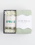 BOXFOX mini black box packed spruce candle and luxe green cozy socks