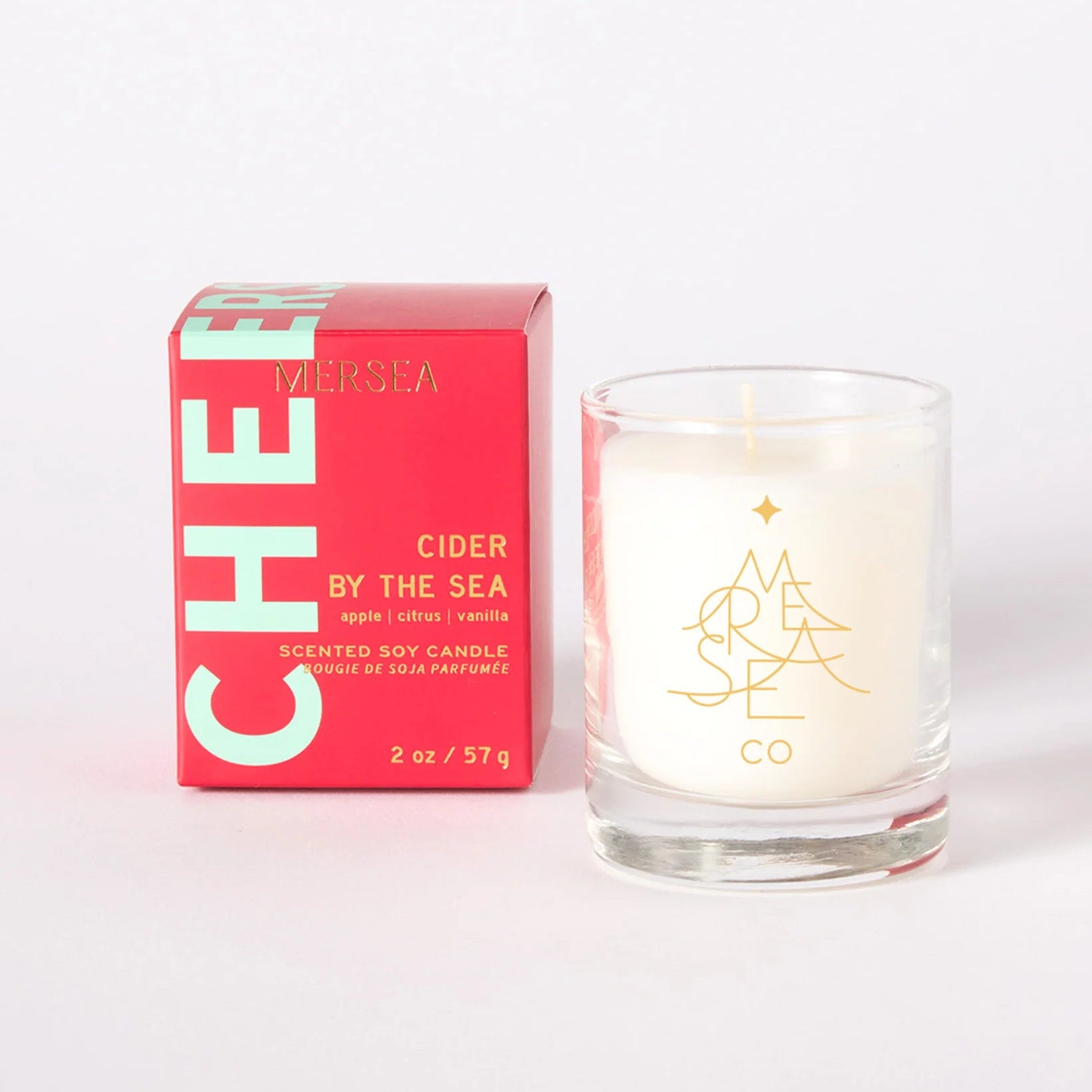 Candle and packaging with 'Cider by the Sea' branding on a white background