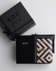 BOXFOX Black Matte Gift box with Black A6 Vegan Leather Notebook, black bullet pen, Goodio Coffee Chocolate Bar, and a single Copper Cow Pour Over Latte Packet