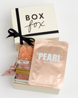 BOXFOX Bridesmaid Gift Box in Creme box with Lapcos Pearl Brightening Mask, Sugarfina sparkling pink gummies, Pinch Provisions pinch velvet bridesmaids essential kit