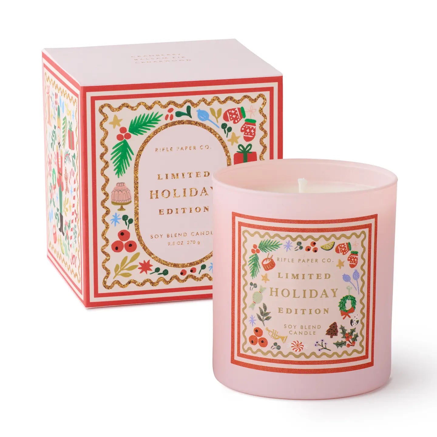 Pink candle with decorative label and matching box on a white background