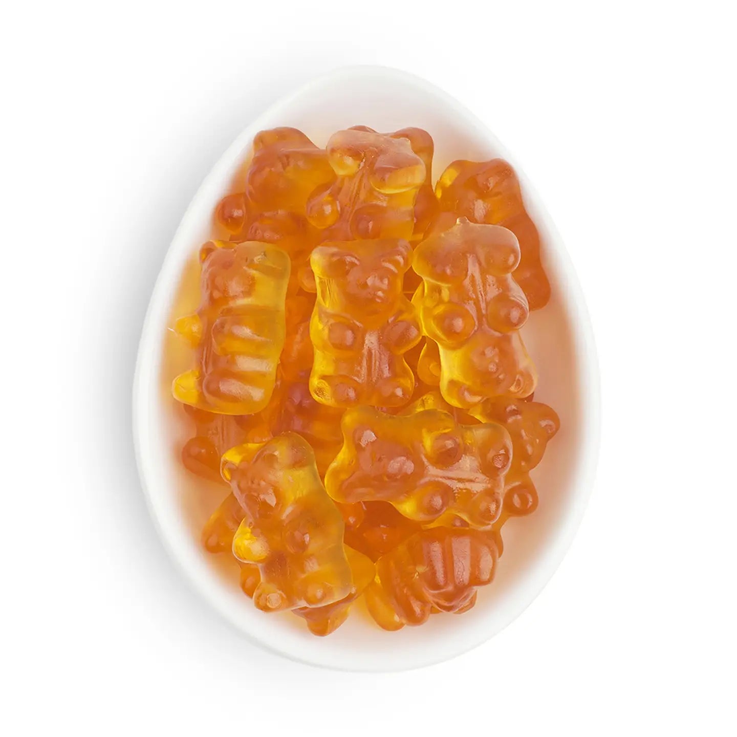 Orange gummy bears in a white bowl on a white background