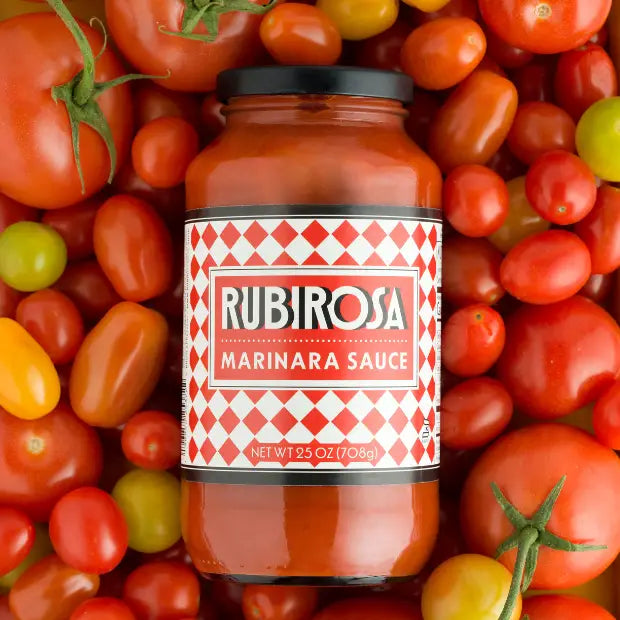 Bottle of Rubirosa Marinara Sauce surrounded by fresh tomatoes