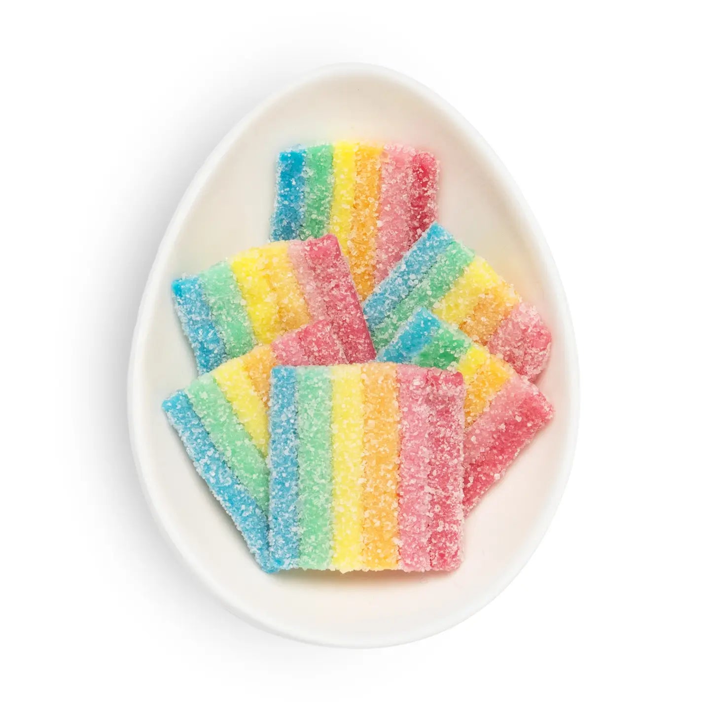 Colorful striped gummy candies on a white plate