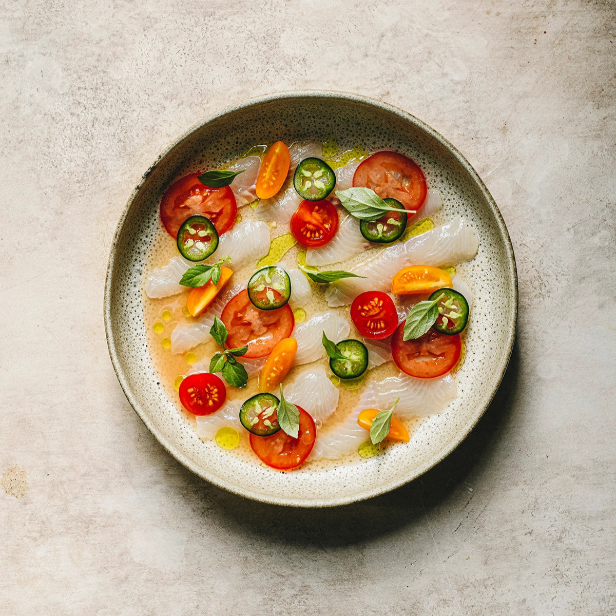 crudo fish dish with jalapeno and tomato