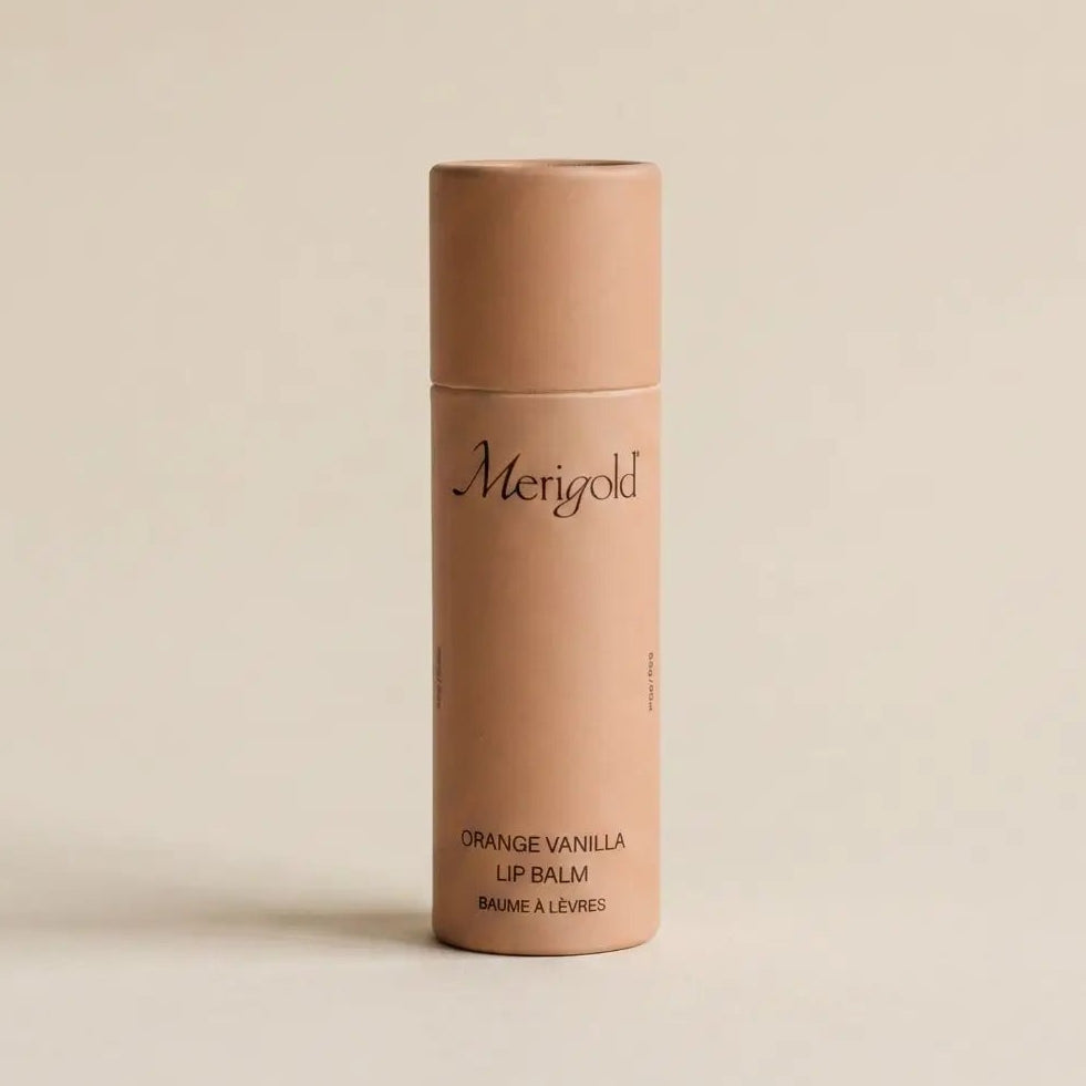 merigold orange lip balm on a beige background