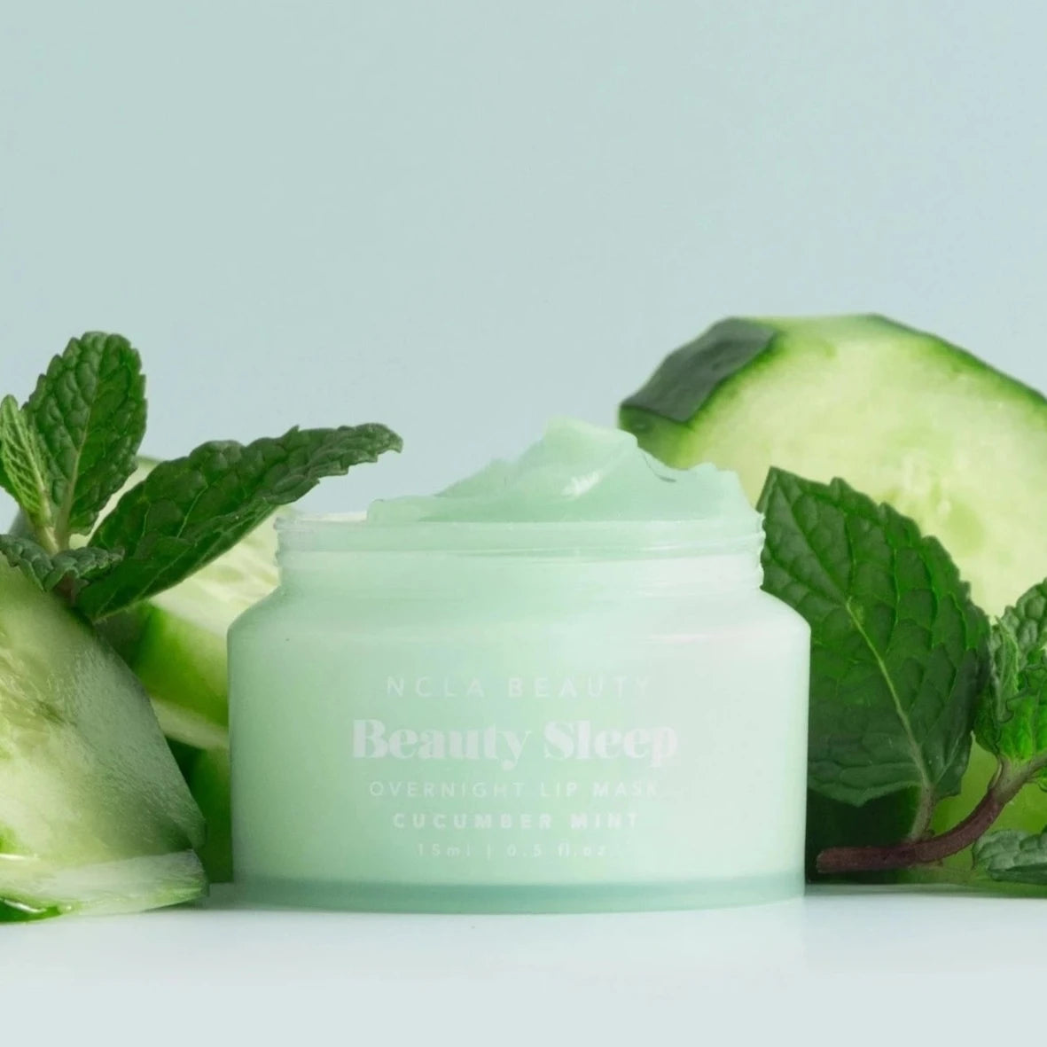 lip mask container surrounded by mint and cucumbers 