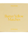 Box of 'Butter Yellow Matches' by PIECEWORK on a beige background