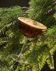 Decorative ornament shaped like a cocktail glass with a slice of lime on a Christmas tree.