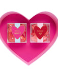Heart-shaped pink container with two candy packages labeled 'Sweet Heart' and 'Pucker Up' on a white background.