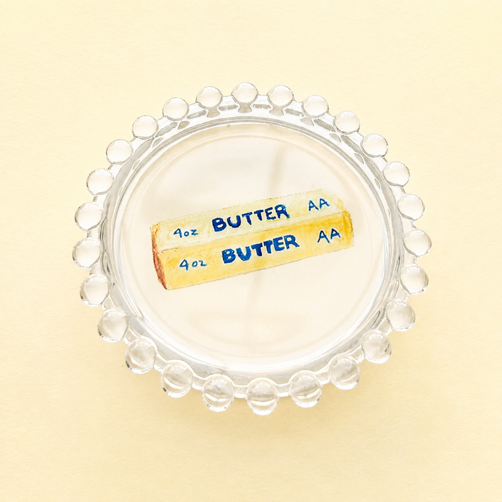 Cream butter dish on a yellow background