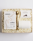 Gold coffee scoop, mocha caramels, cream mug and bag of coffee packed in BOXFOX