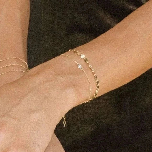 Petite CZ Bracelet on wrist with other bracelets 