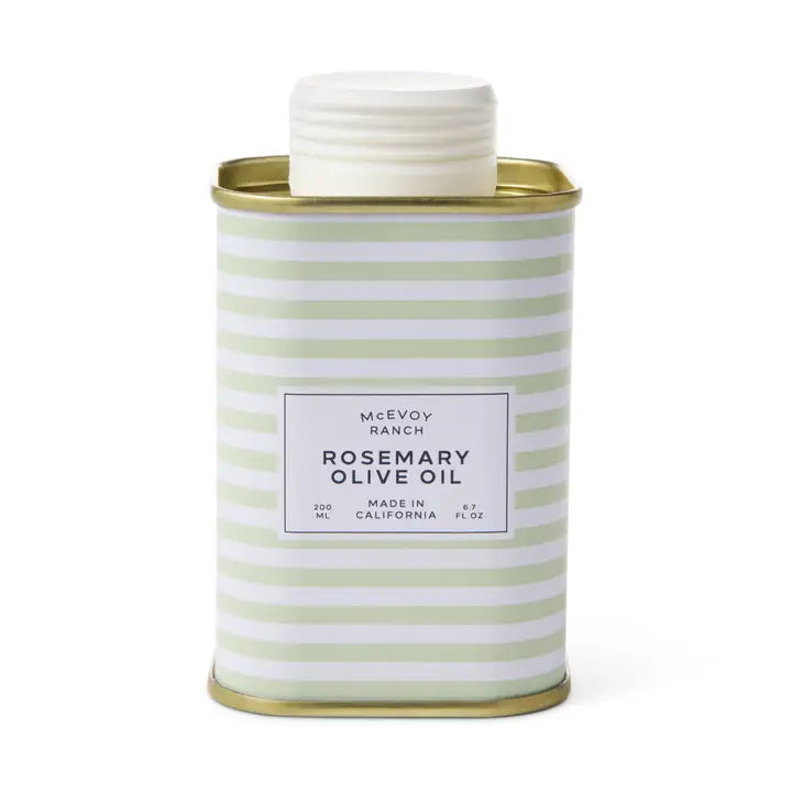 A rectangular metal tin of McEvoy Ranch Rosemary Olive Oil, featuring a white lid and a body with pale green and white horizontal stripes, set against a plain white background.